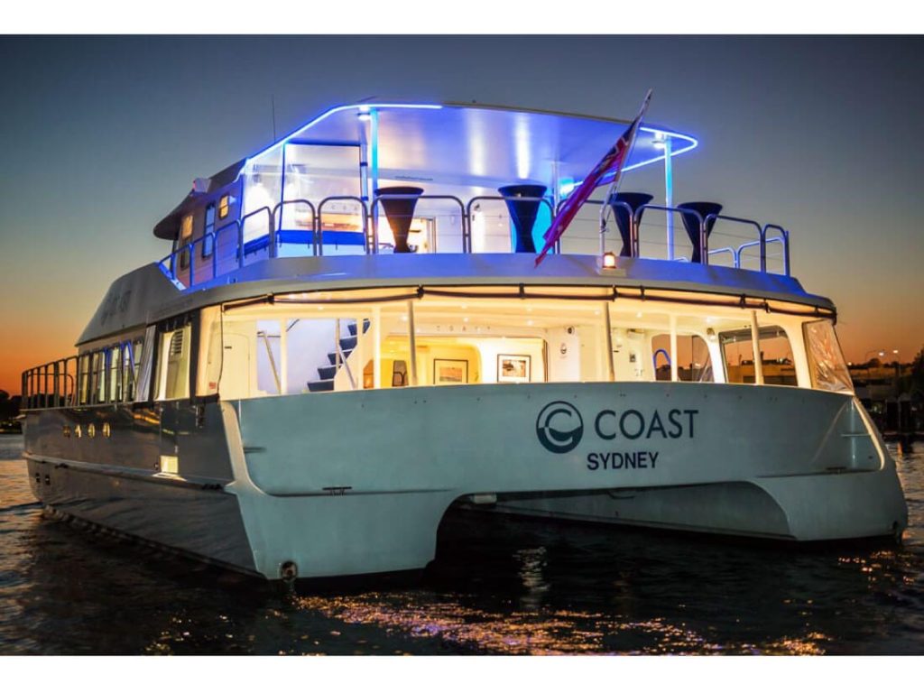 coast party boat with lights at night on the Sydney Harbour